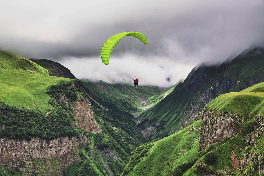 person paragliding near mountain range, cloud, mist, fog, foggy HD wallpaper