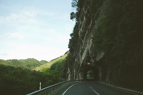 sky, road, tunnel, winding, hills, grass, trees, mountains HD wallpaper