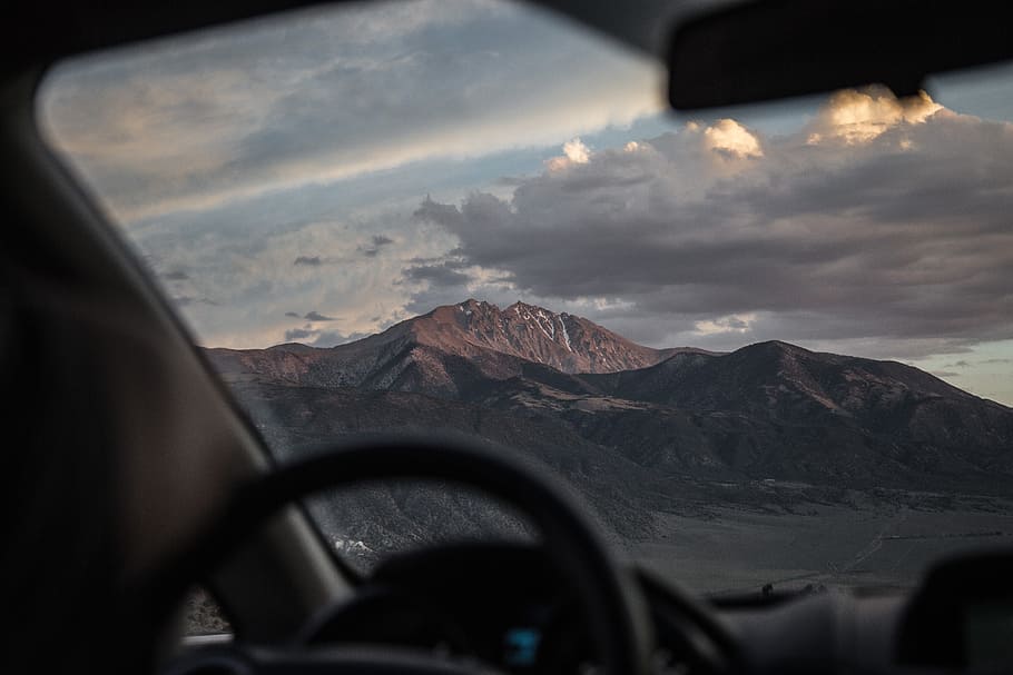 brown mountain with cloudy sky, car, steering wheel, window, windscreen HD wallpaper