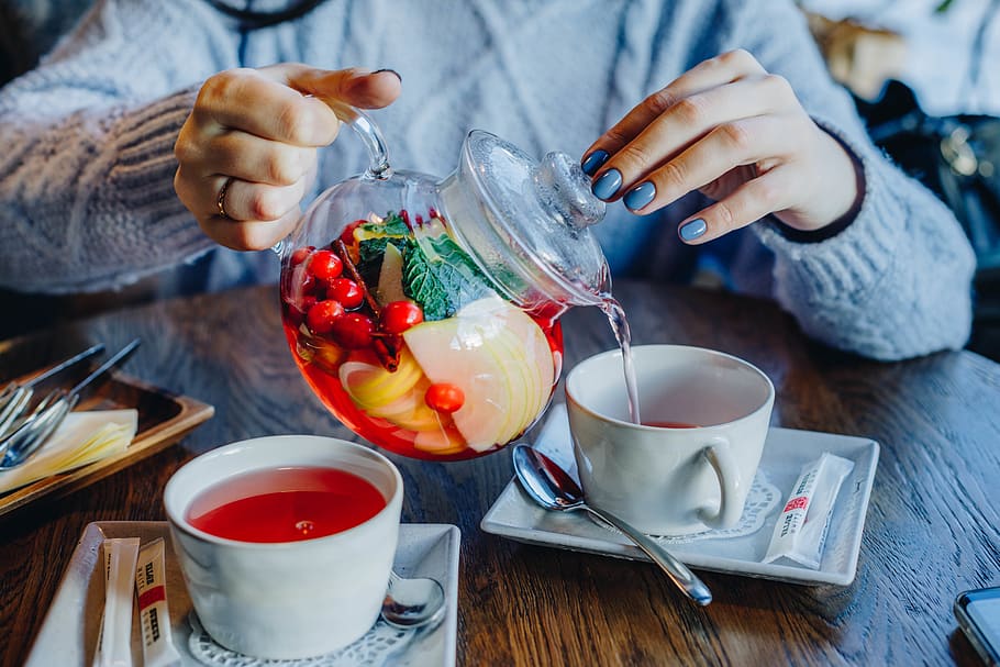 Woman Filling Tea in Cup on Table, beverage, blur, close-up, depth of field HD wallpaper