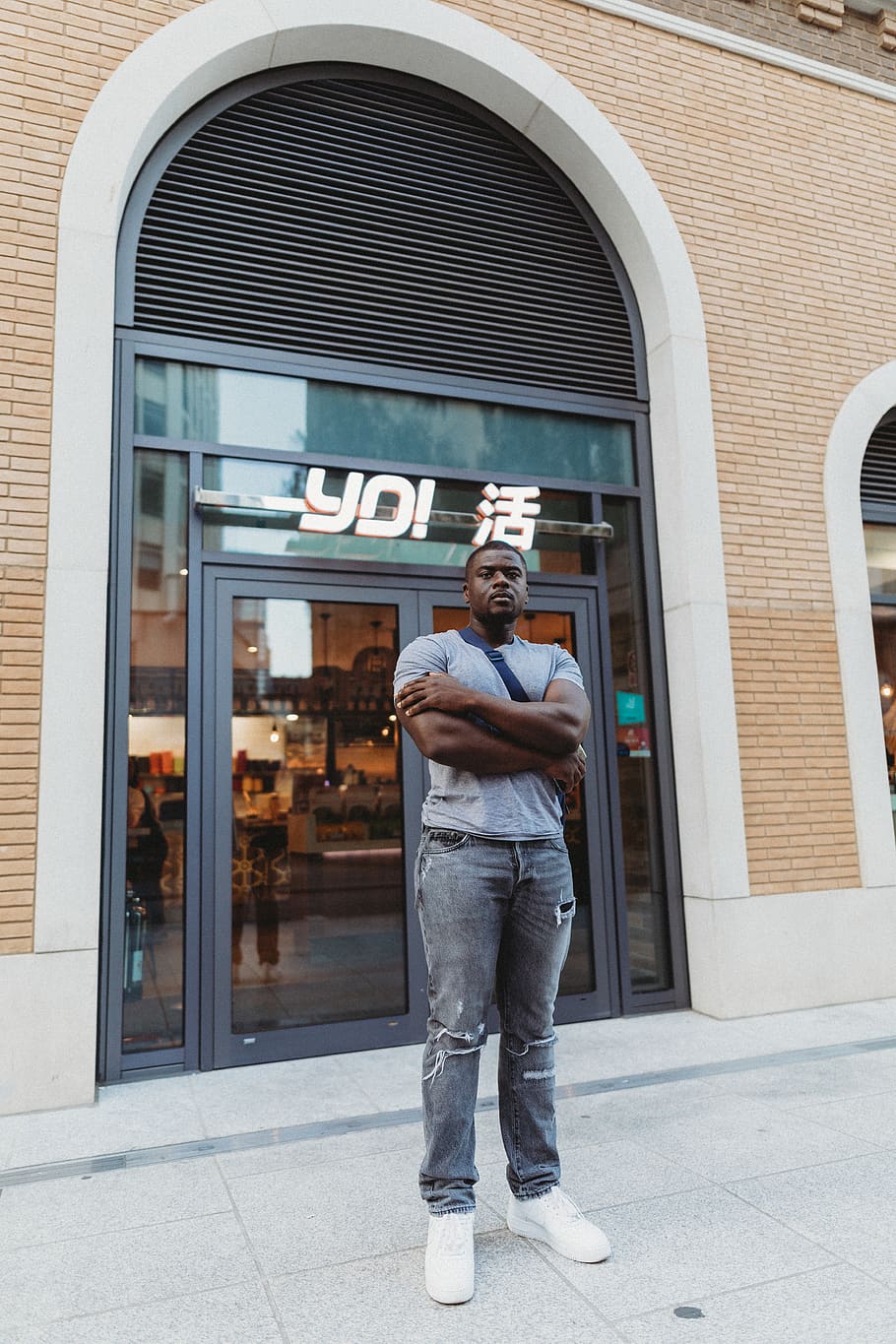 man standing on Yo! store front, person, human, people, building HD wallpaper