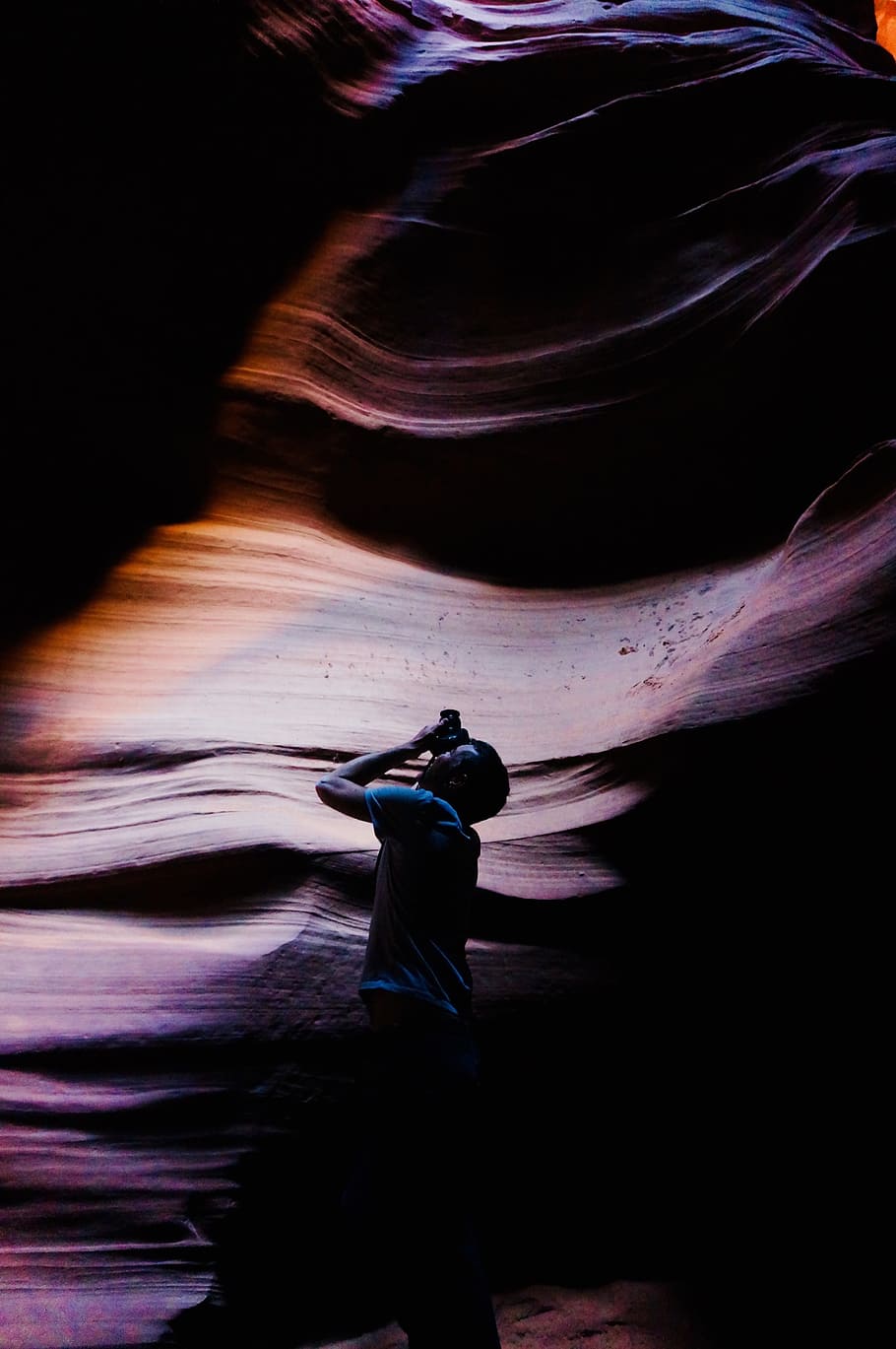 man standing holding camera taking photo, male, rock, looking up HD wallpaper