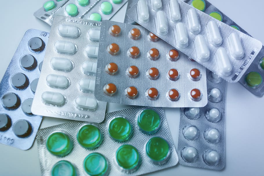 Medicine pills in packs on the table. Full screen background