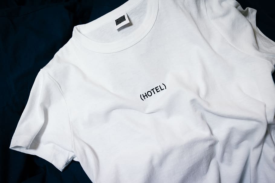 white hotel-printed crew-neck shirt on black surface, text, western script, HD wallpaper