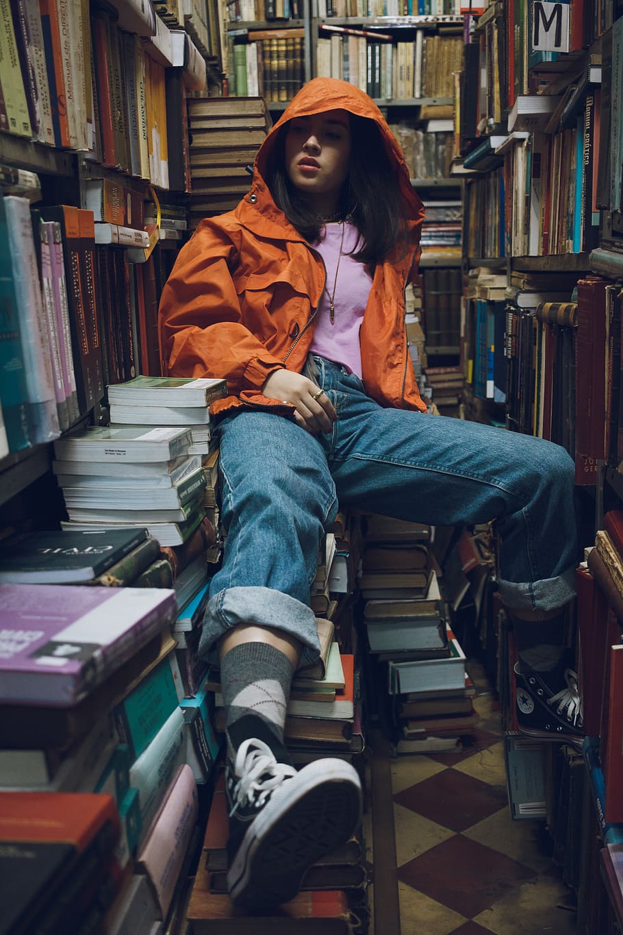 Woman Wearing Orange Jacket Sitting Inside Library, adolescent