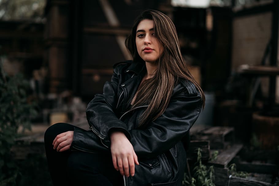 sitting woman wearing leather jacket, clothing, apparel, coat