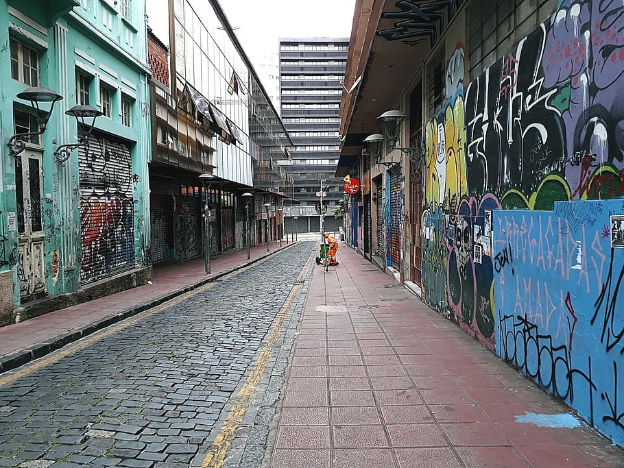 empty alleyway between buildings during daytime, graffiti, direction