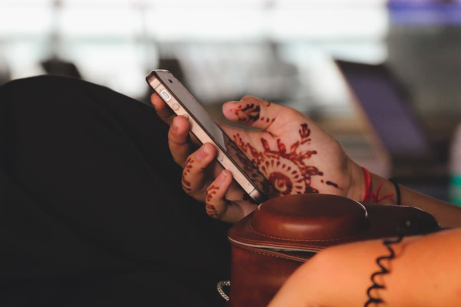 person holding black iPhone, one person, tattoo, indoors, real people HD wallpaper