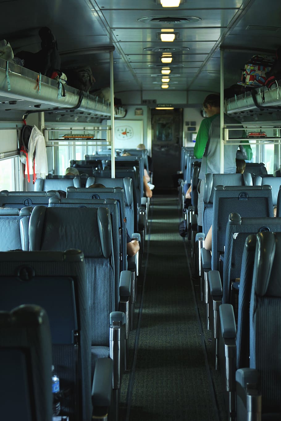 man standing in bus, cushion, human, canada, train, person, transportation