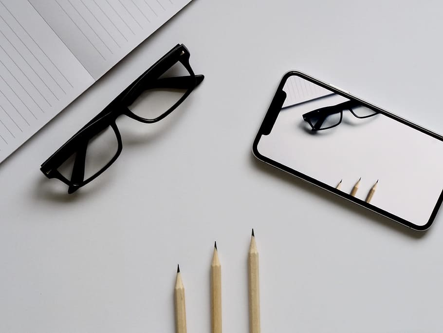 Three Pencils, Eyeglasses, and Smartphone on White Table, black HD wallpaper