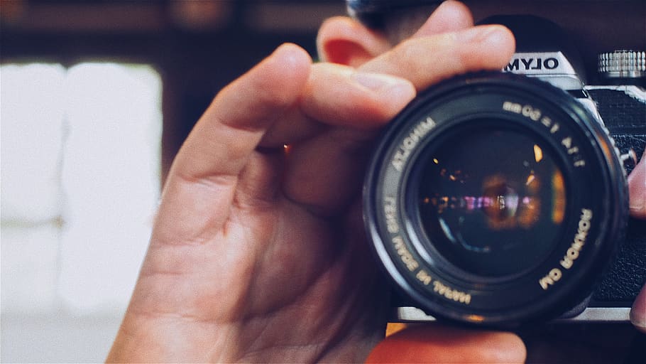 Person Holding Olympus Milc Camera, blurred background, camera lens HD wallpaper