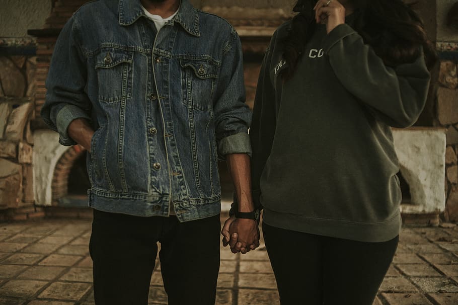 man and woman holding hands, human, person, apparel, clothing