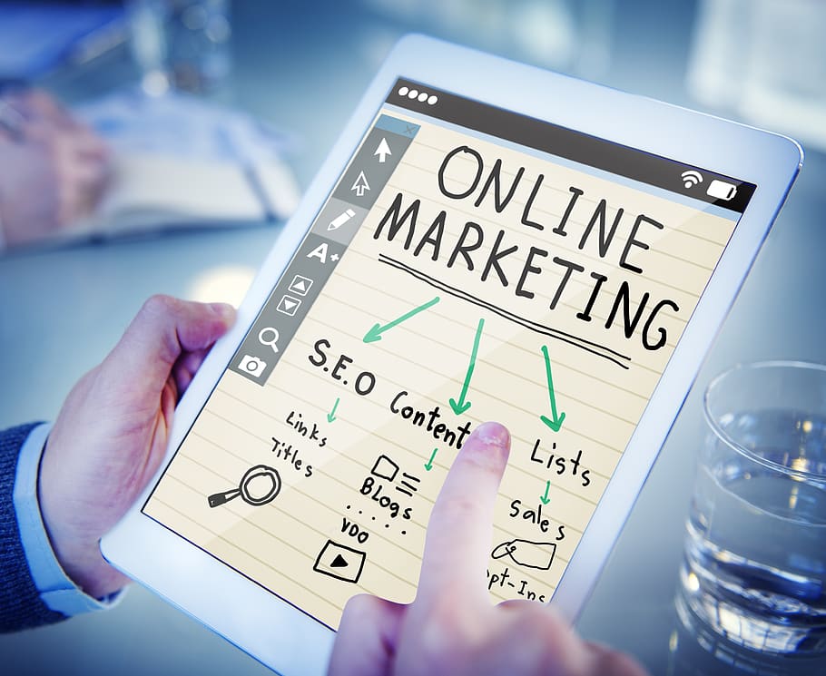 Person Holding Turned-on Tablet Displaying Online Marketing, close-up HD wallpaper
