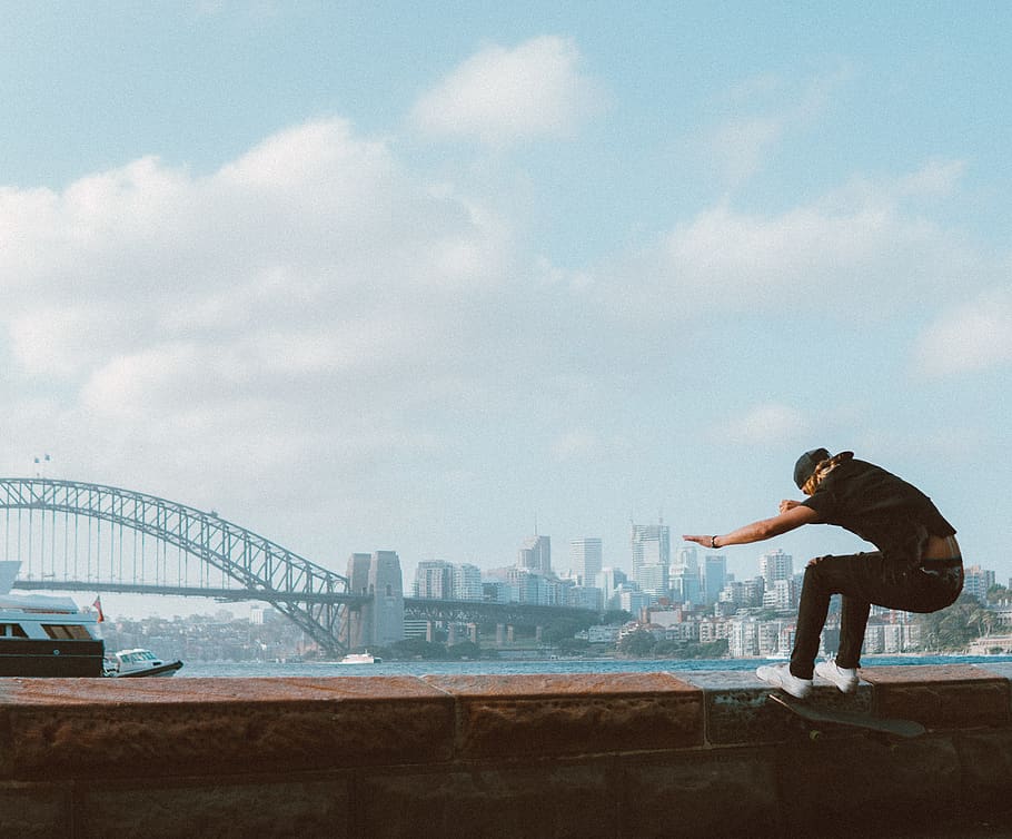 Man Doing Trick on Skateboard, action, adult, athlete, bay, bridge, HD wallpaper