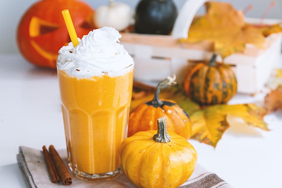 Pumpkin smoothie. Small pumpkins and drink on the white background HD wallpaper