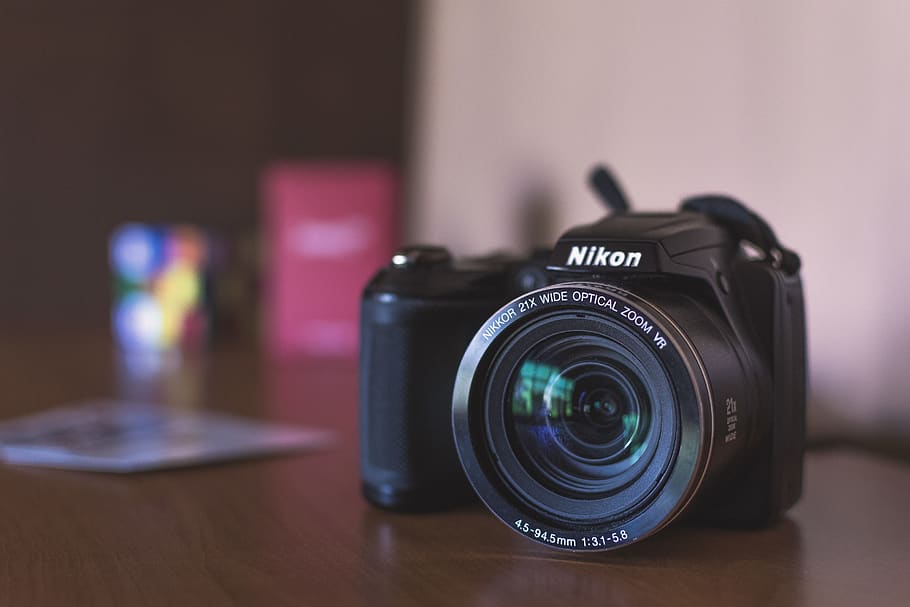 black Nikon bridge camera on table, camera - photographic equipment