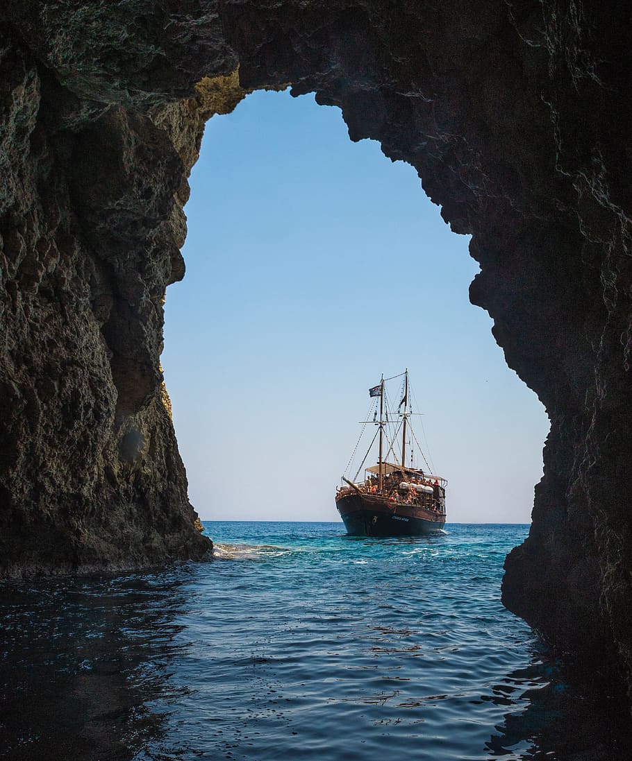 Brown Boat on Body of Water Towards Tunnel, bay, beach, cave