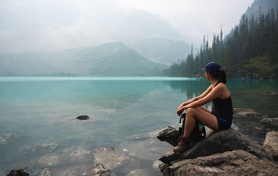 woman sitting on rock near body of water, female, forest, woodland