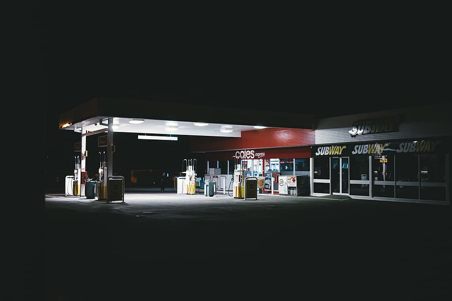 white and red gasoline station, gas station, restaurant, night