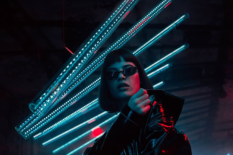 woman standing below blueneon lights, glasses, sunglasses, illuminated HD wallpaper