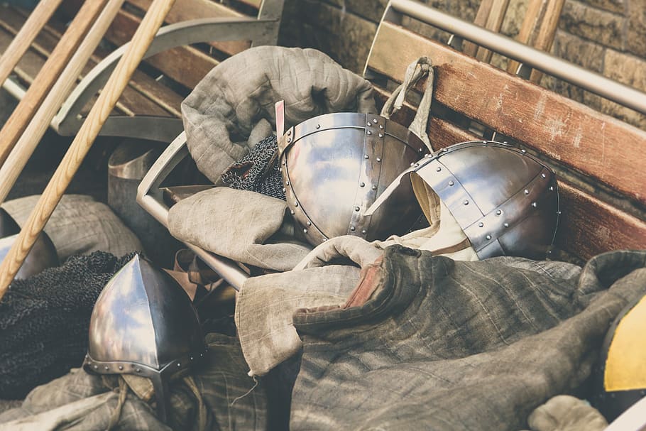 Two Gray Stainless Steel Soldier Helmet on Brown Wooden Bench HD wallpaper