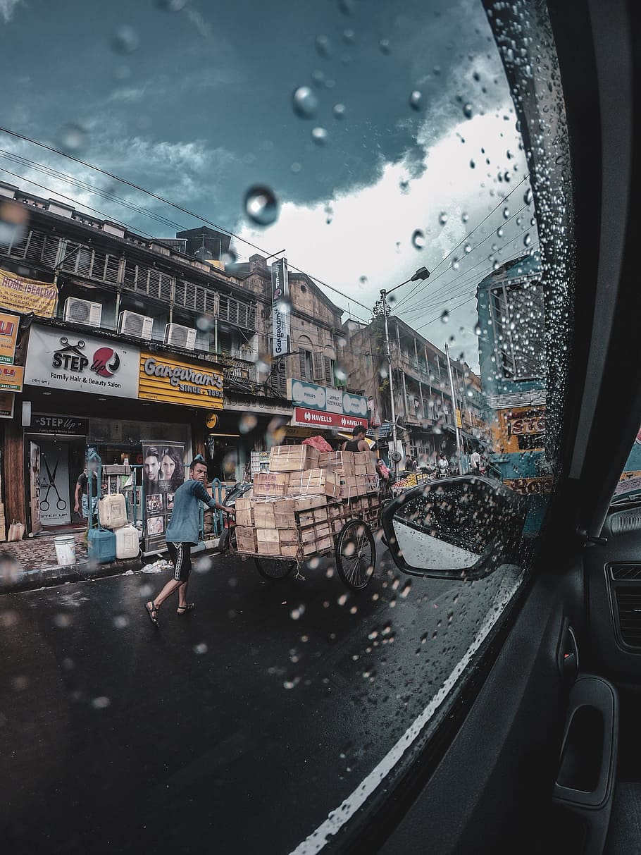 man pushing cart on road, window, person, street, market, seller