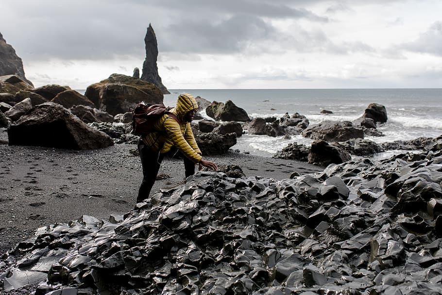 Person Wearing Hoodie Touching Stone in Seashore, action, beach HD wallpaper