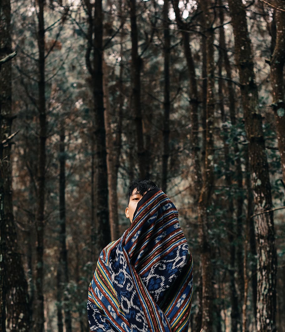 boy with shawl standing between forest, apparel, clothing, person HD wallpaper