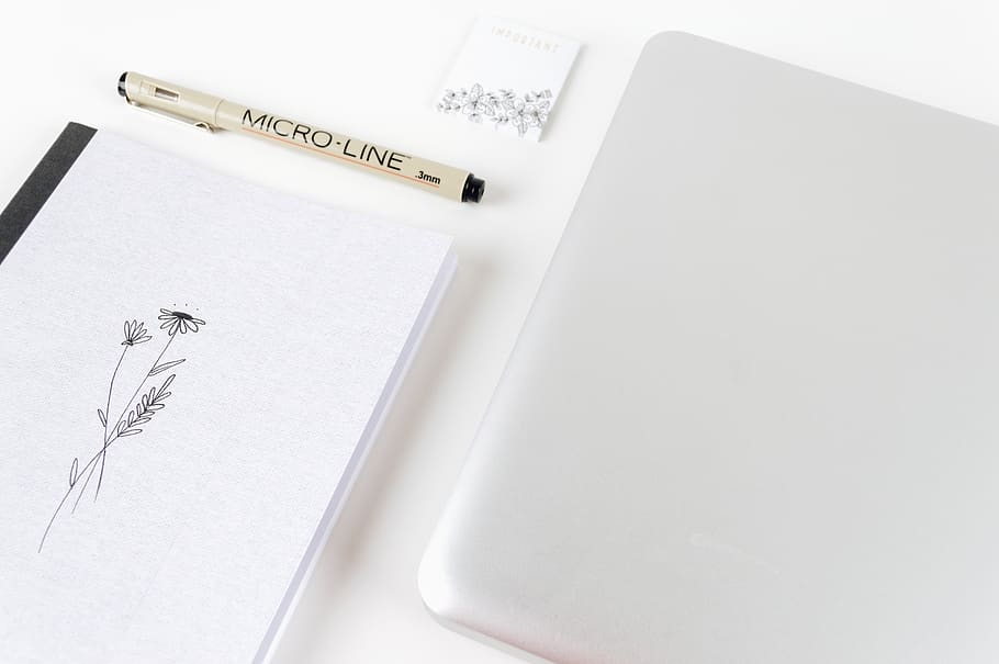 white laptop computer beside micro line pen, white color, studio shot HD wallpaper