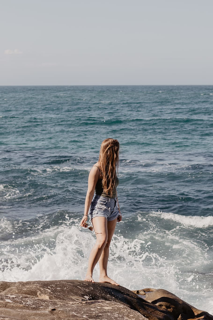 woman standing on rock near water, girl, sea, ocean, seaside