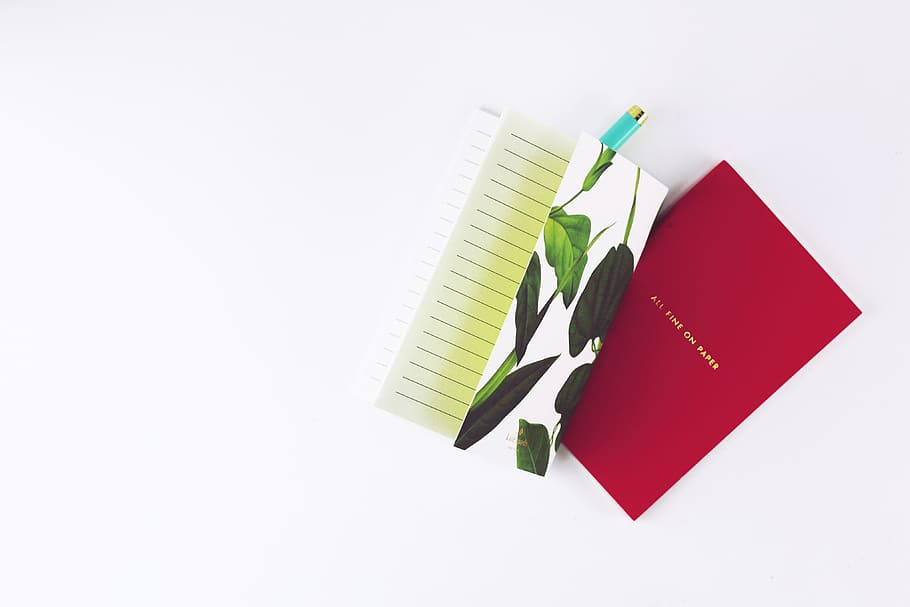 red notebook placed on white surface, indoors, studio shot, white background HD wallpaper