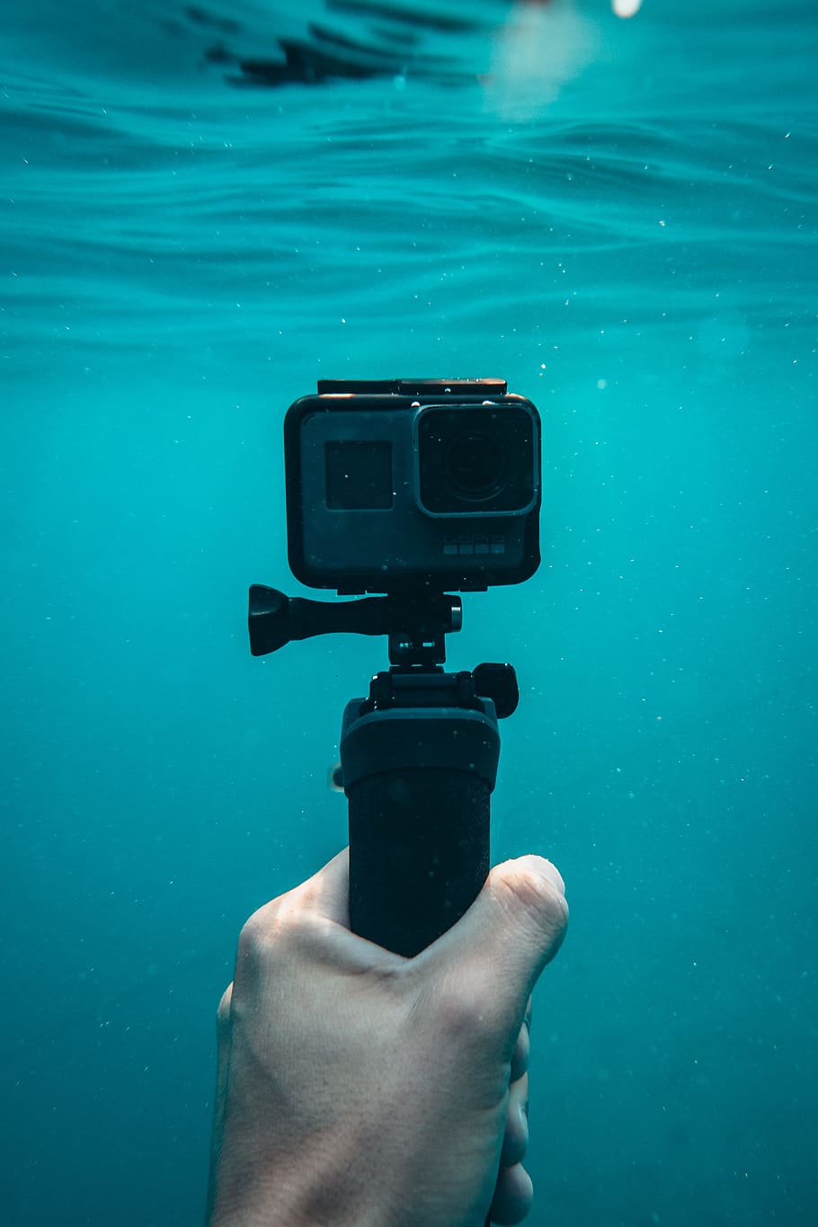 person holding action camera in underwater, gear, equipment, hand