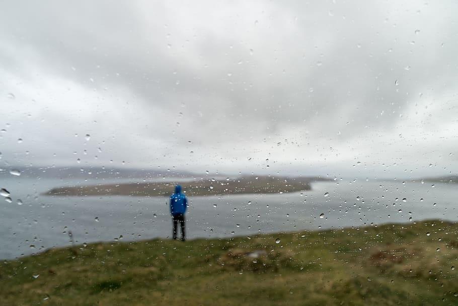 Man Standing on Grass Near Water, bad weather, beach, blur, clouds HD wallpaper