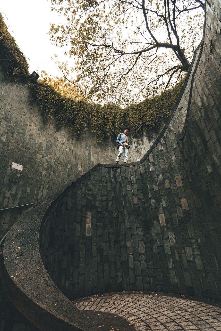 man inside artificial hole with stair, singapore, person, staircase HD wallpaper