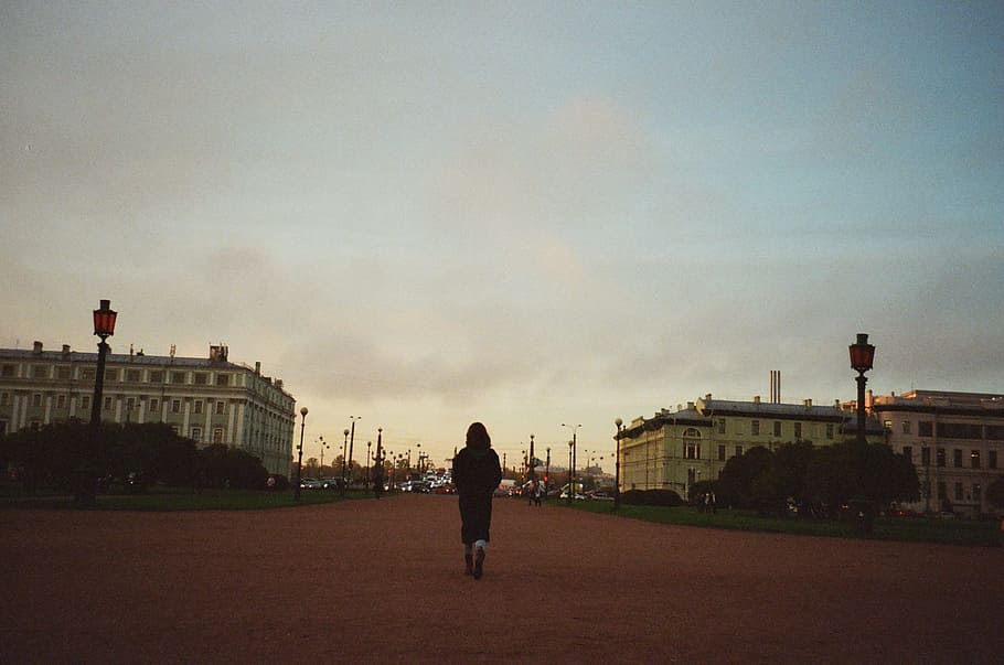 Woman Walking Towards City, architecture, buildings, clouds, dusk HD wallpaper