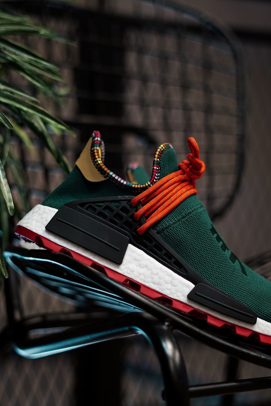 unpaired green and red adidas NMD shoe 