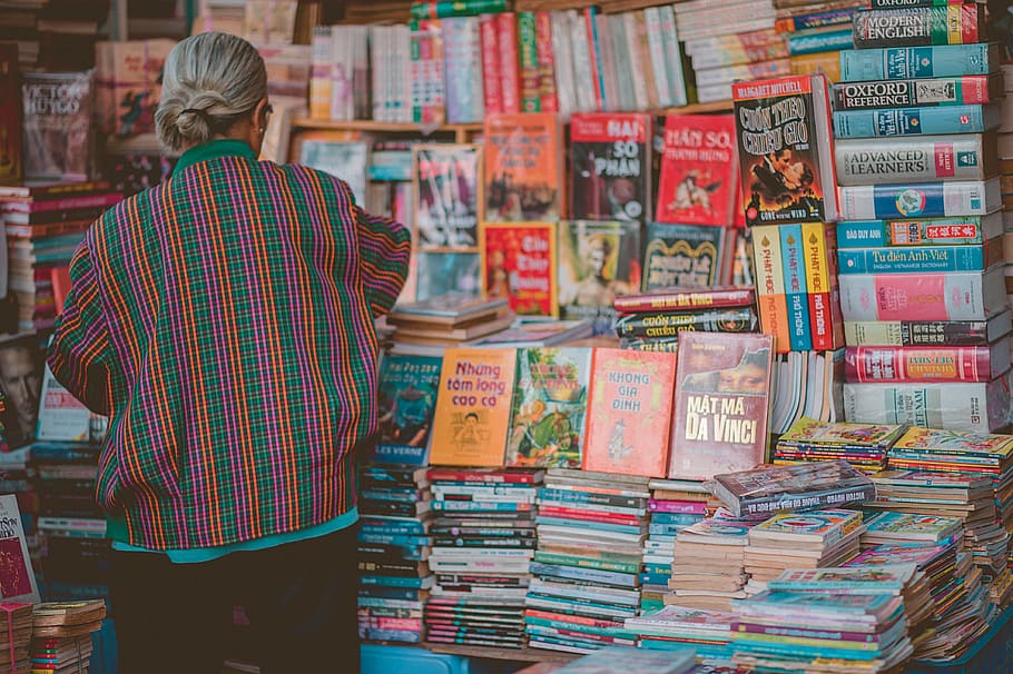 Woman Standing Beside Book Store, back view, book bindings, book stack HD wallpaper