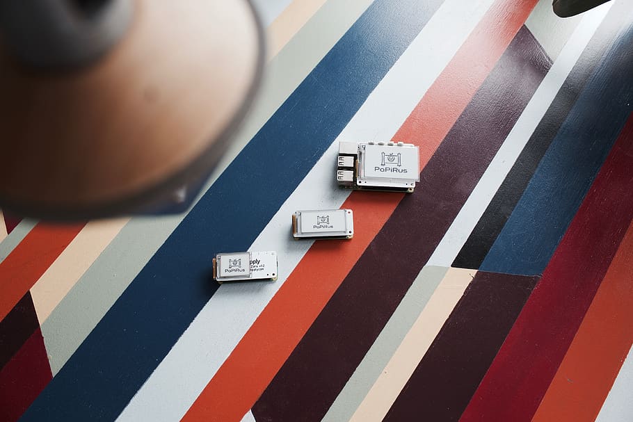 three white electronic devices on multicolored surface, stoke gifford HD wallpaper