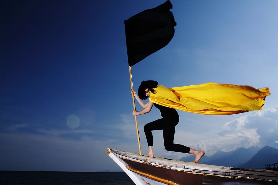 Woman Holding Black Flag, action, barefoot, beach, boat, cape HD wallpaper