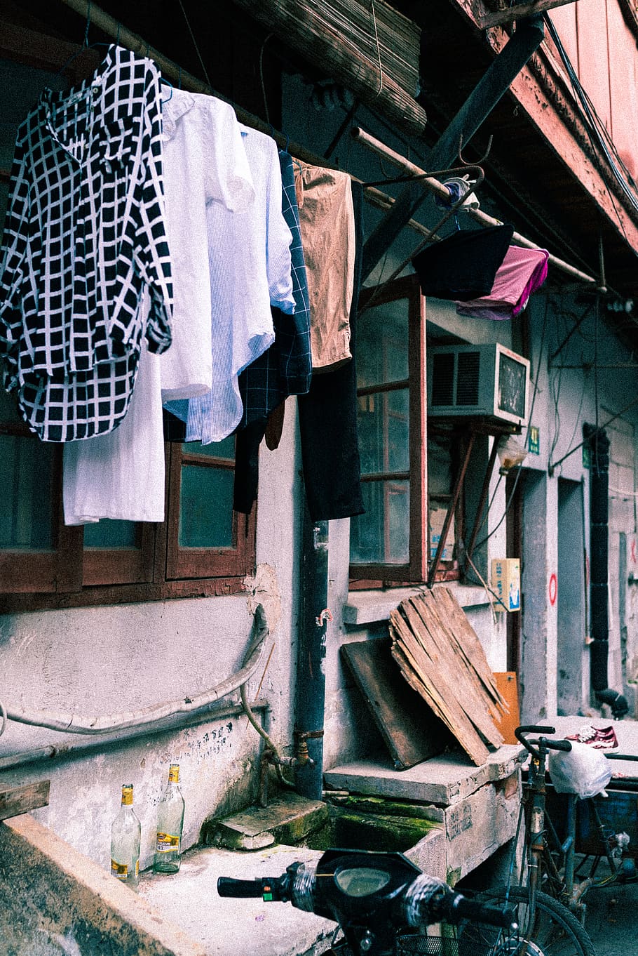 assorted clothes hanged on clothesline outside window, shanghai