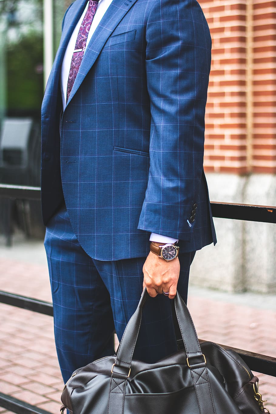 Person Wearing Blue Suit Jacket and Dress Pants Holding Tote Bag
