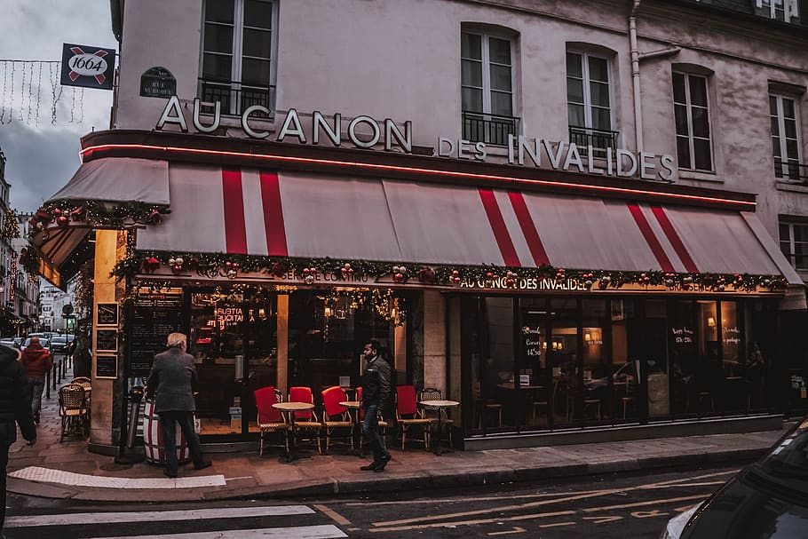 few people standing near restaurant, human, person, road, transportation