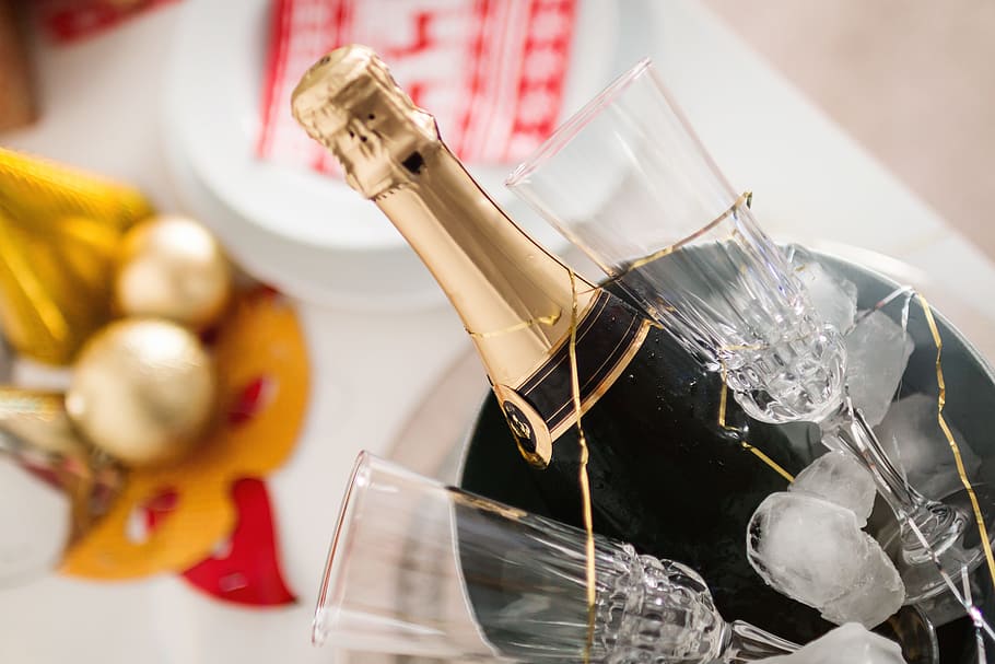 Party! Glasses and bottle of Champagne in an ice container. Happy New Year concept. HD wallpaper