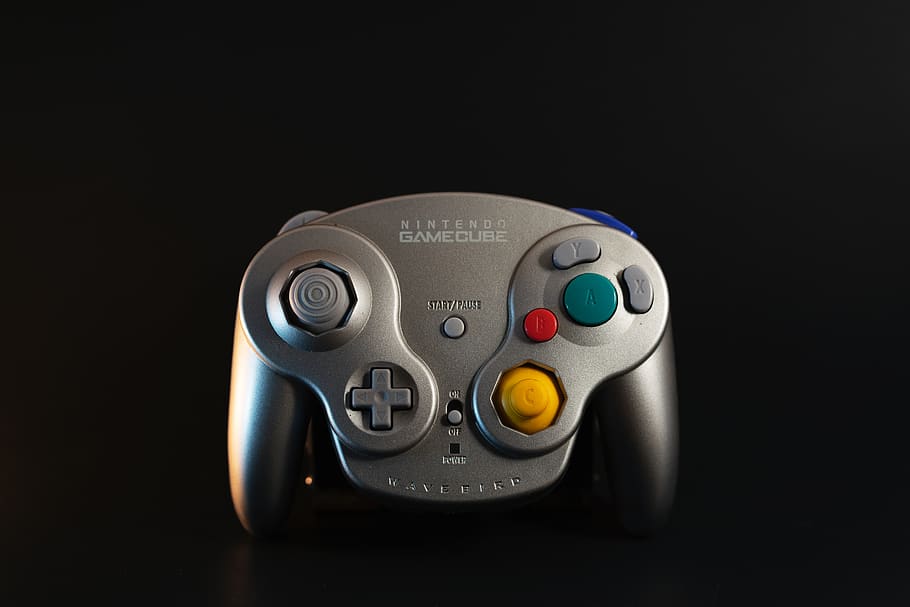 gray Nintendo Game Cube controller, black background, technology