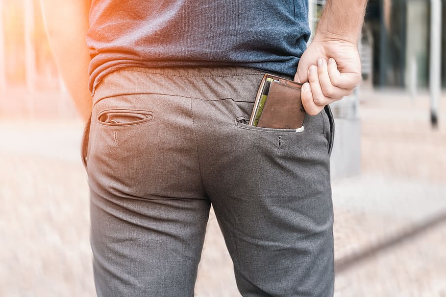 Man’s hand taking wallet from his own pocket, one person, midsection HD wallpaper