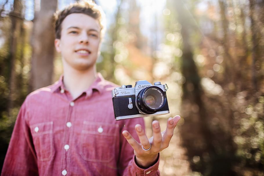man holding black and gray camera at daytime, male, levitation HD wallpaper