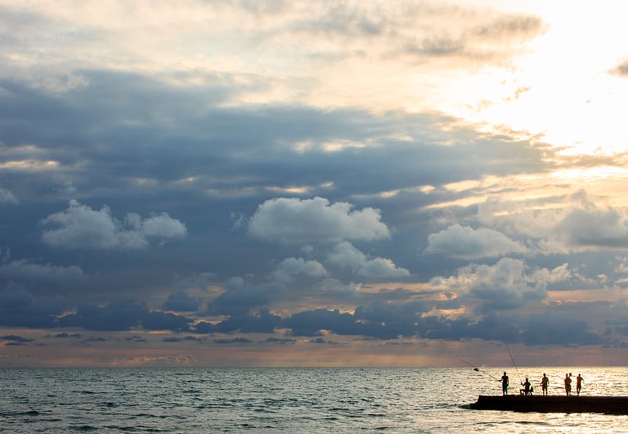 Silhouette Photo of People Standing on Dock Near Sea, backlit HD wallpaper