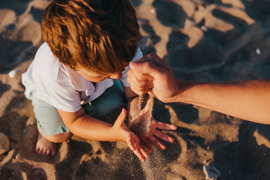 person pouring sand into boys hands, child, kid, play, beach HD wallpaper