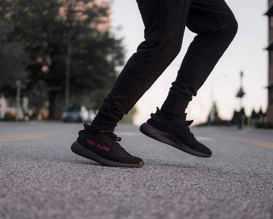 HD wallpaper: person wearing black-and-red adidas Yeezy Boost 350 sneakers | Wallpaper Flare