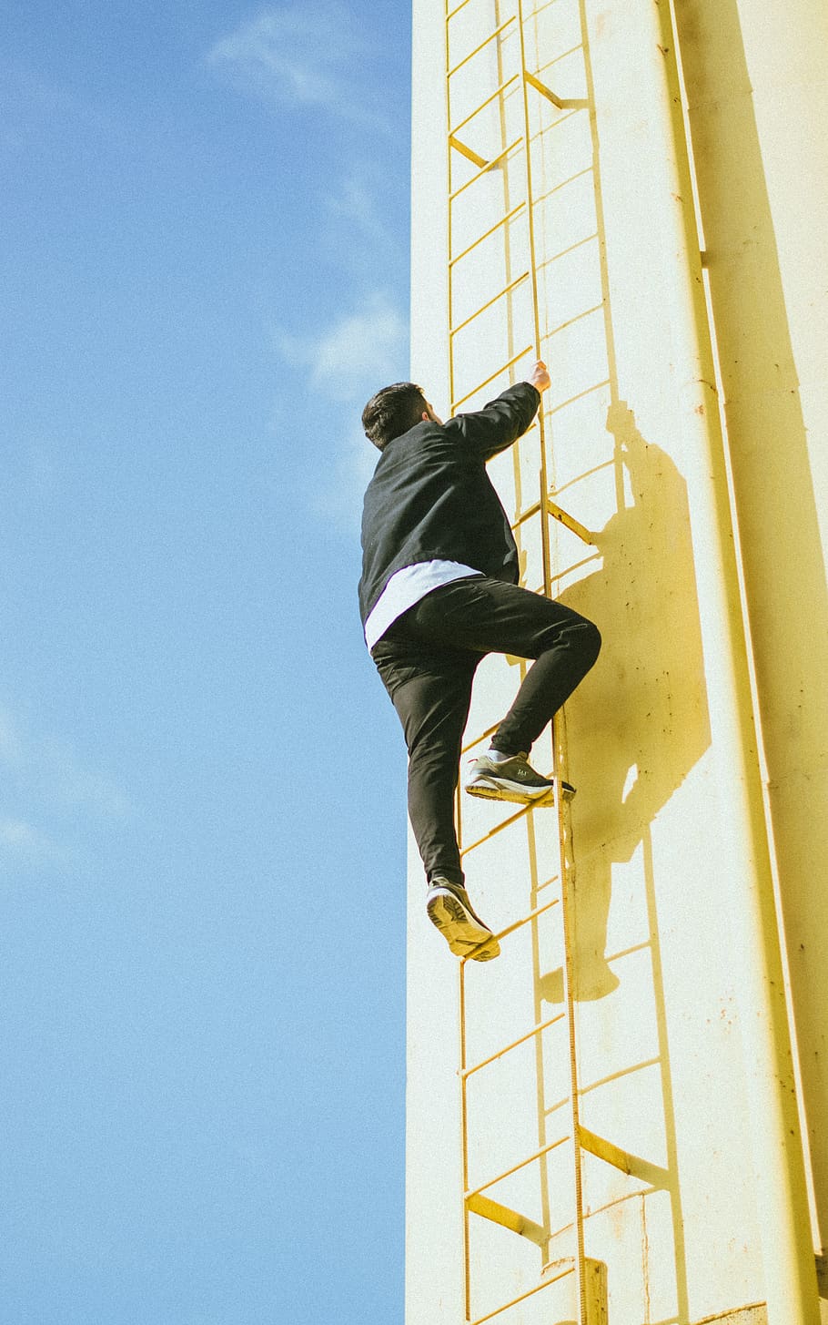 man climbing on ladder during daytime, footwear, shoe, apparel